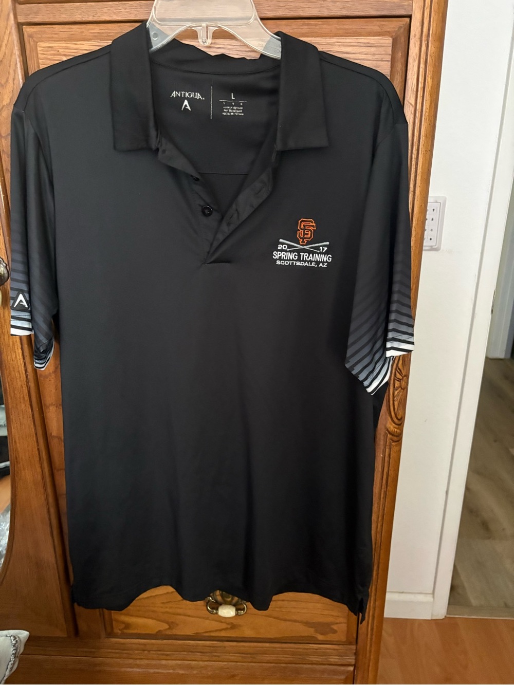 Antigua Men’s Black SF Giants Spring Training Polo with Orange Logo